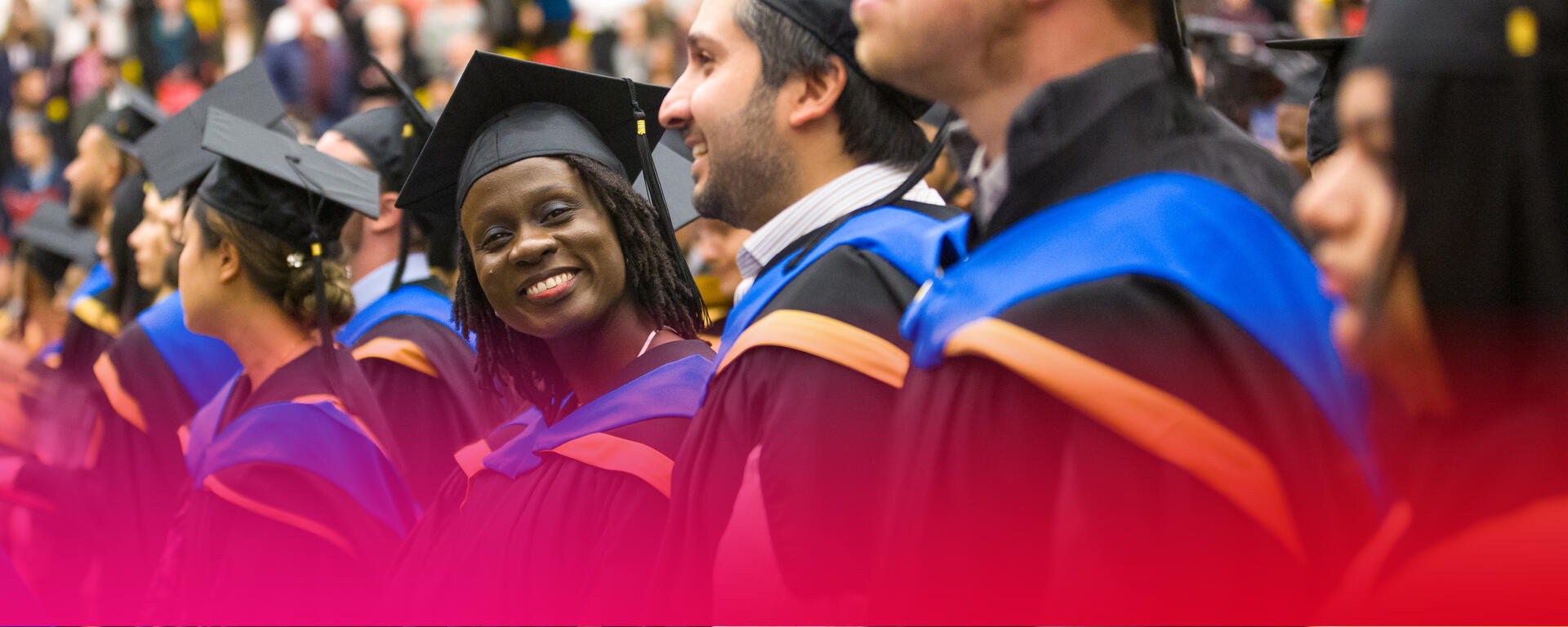 students at convocation, wearing caps and gowns