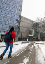 Student walking into Hunter Student Commons