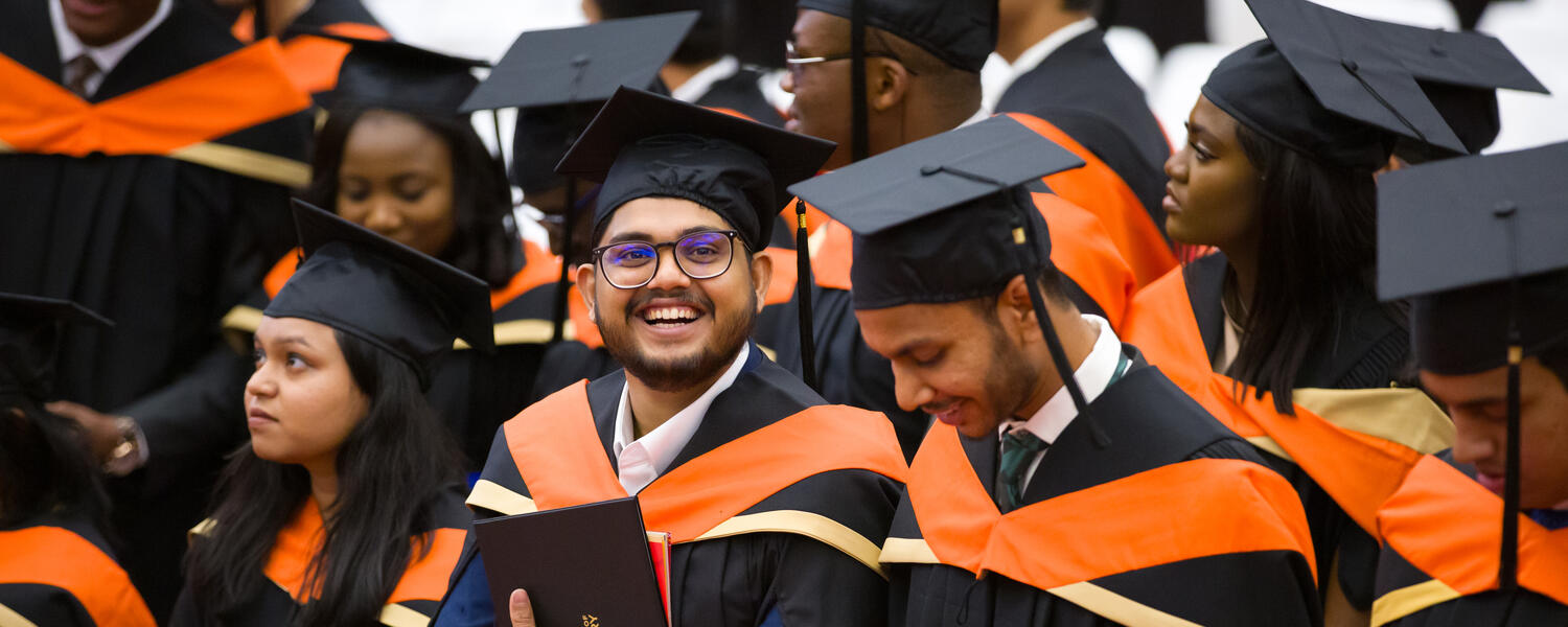 A group of graduates smile in a candid shot