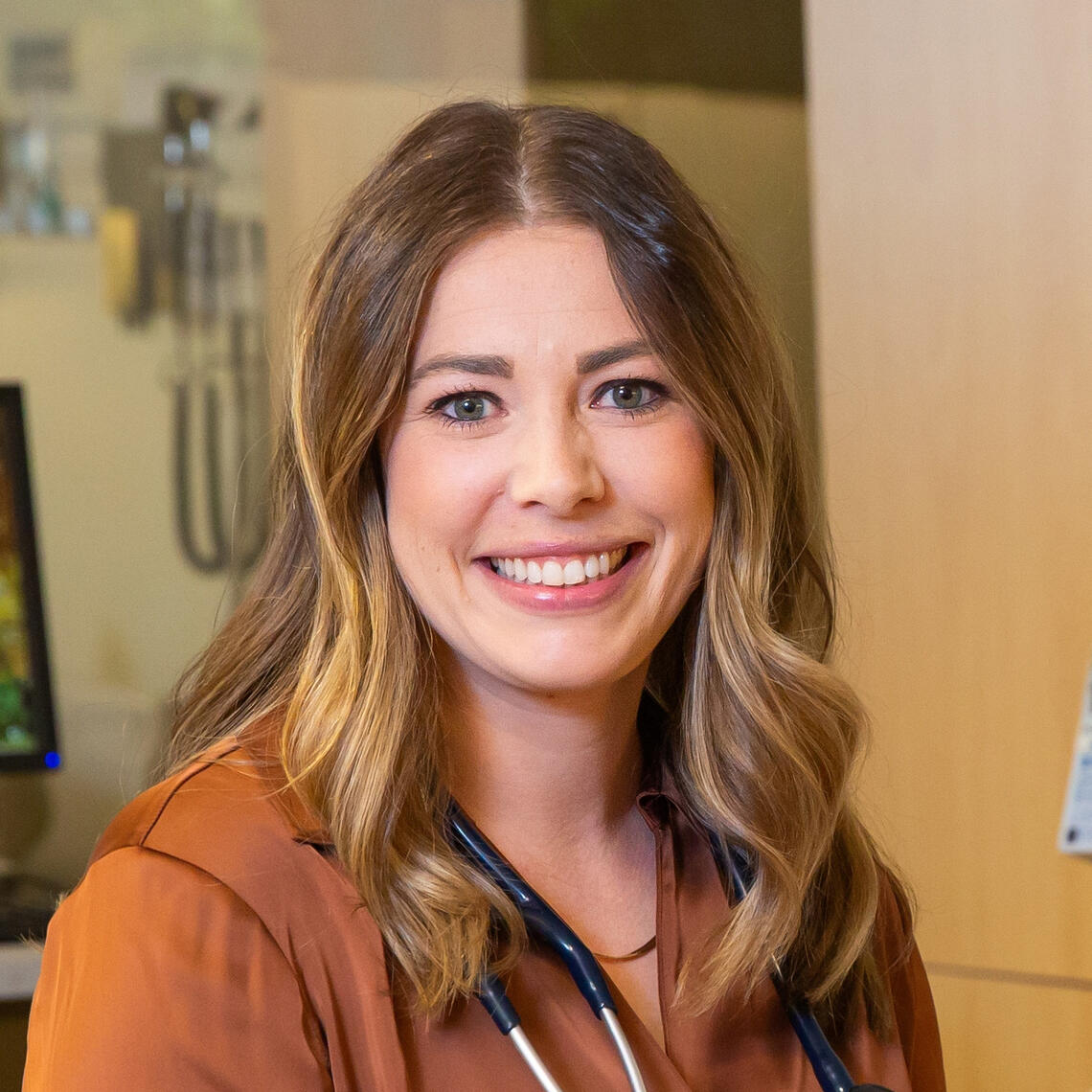 A woman smiles in a hospital room