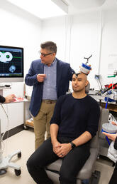 A group of people surrounding a brain scan