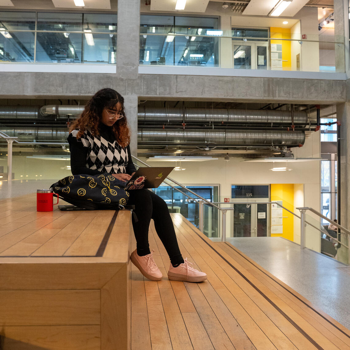 Student sitting using a laptop