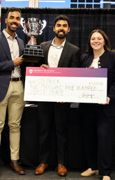 A group of people holding a large check