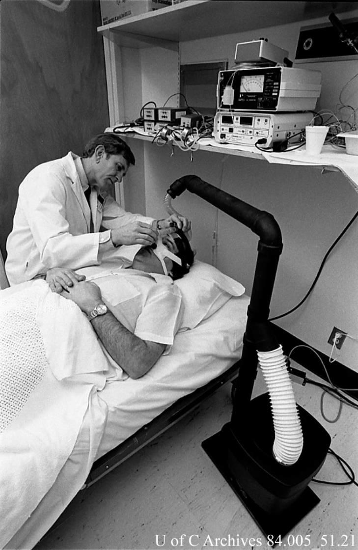 Dr. John Remmers Heritage Fund researcher, Dr. John Remmers, with a patient wearing a "sleep mask" designed by Dr. Remmers, December 1985.
