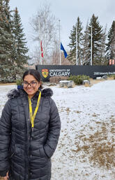 Fairooz Shafin standing in front of UCalgary entrance