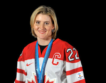 woman in a hockey jersey with a gold medal around her neck