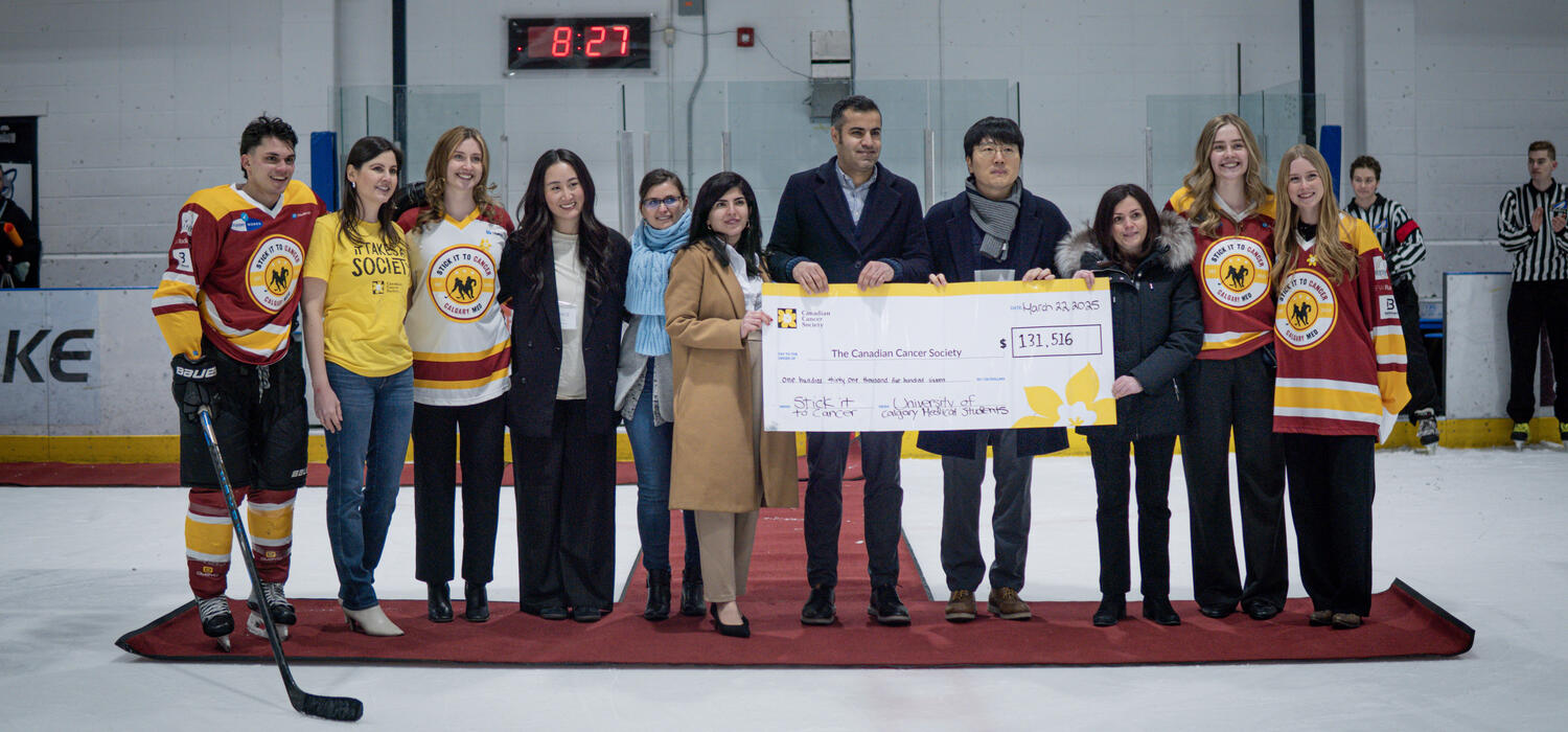 A group of people holding an oversized cheque