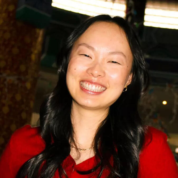 A woman smiles at the camera