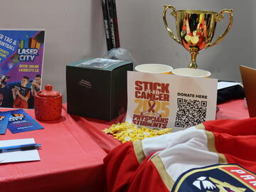 A table filled with a QR code and trophy