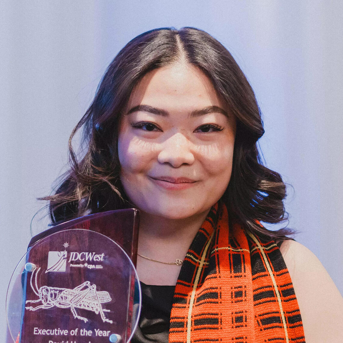 A woman holding an award 