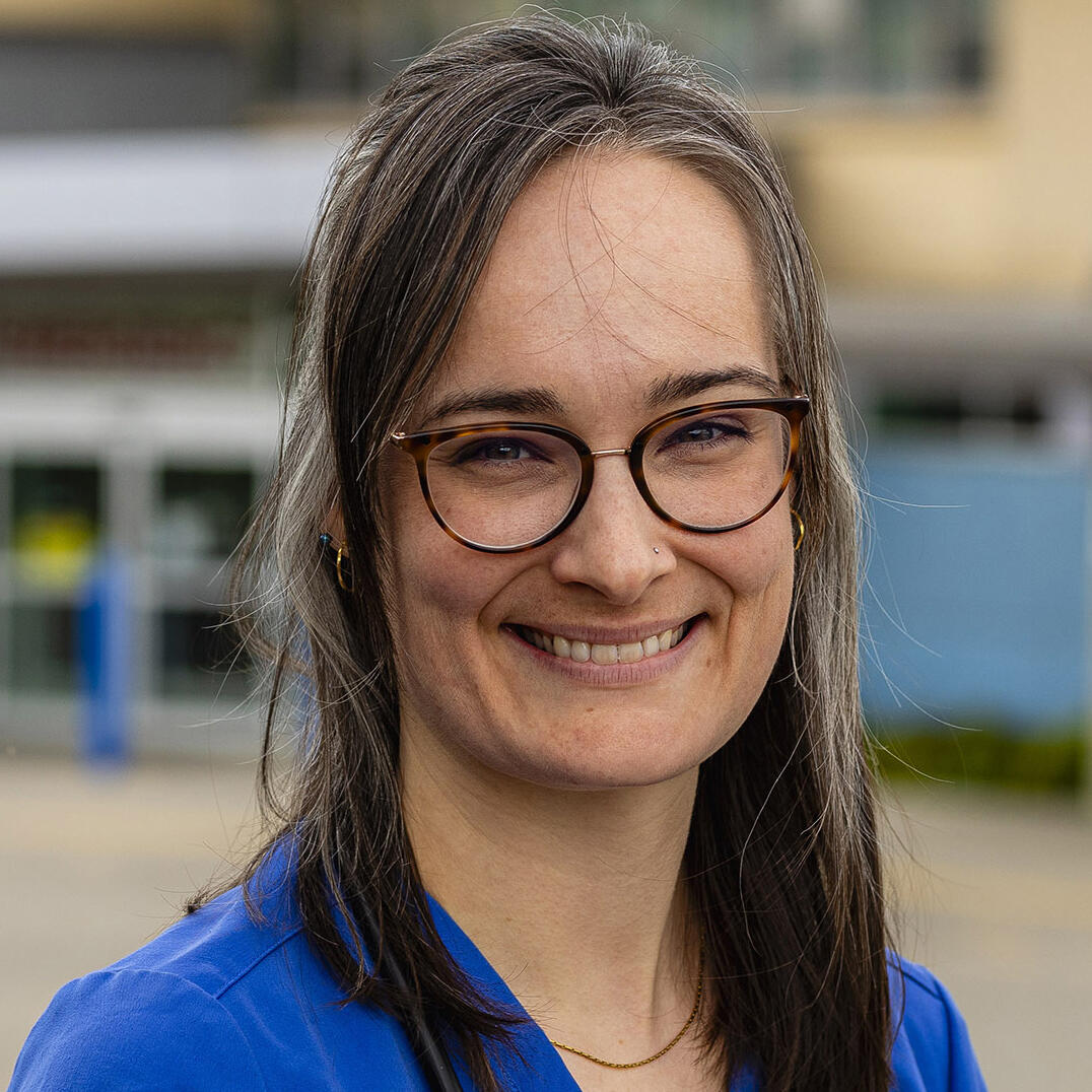 A woman in blue scrubs