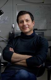 A man sitting there next to a microscope